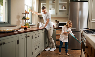 Father and Daughter Cleaning Cheerfully