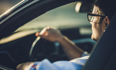 Man sitting in car commuting to work