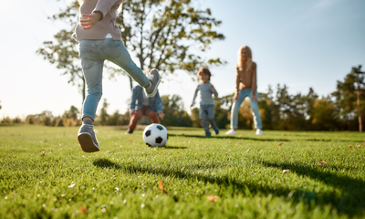 Children Playing in a Green Field