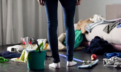 Person Standing in A Cluttered Apartment