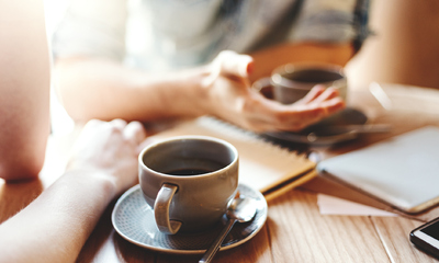 Two People Socializing with Coffee on Table 