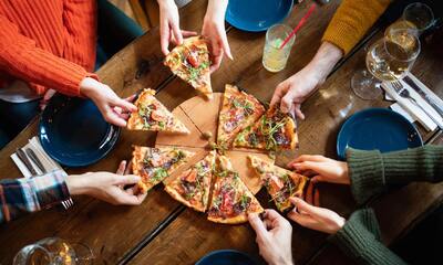 Friends Enjoying a Slice of Pizza