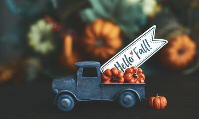 Trucking holding sign and pumpkins