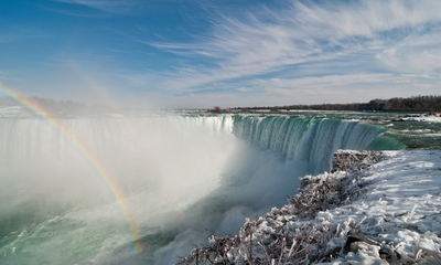 Niagara Horseshoe Falls in winter with double rainbows