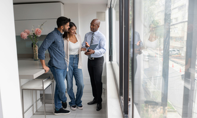 Real estate agent talking to a couple buying an apartment