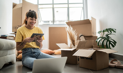 Young woman looking at a photo frame at new house