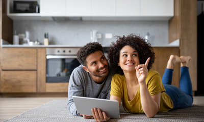 Couple using app on tablet deciding on interior removations